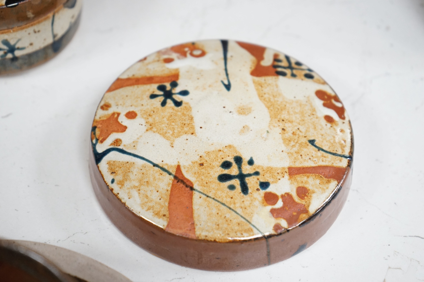 Colin Pearson (1923-2007), a large stoneware cup and saucer, a JG cylindrical vase, Scott Marshall (1936-2008), a Boscean Pottery slip decorated box and cover, a similar cover lacking base and a ?Davies ‘Angels’ dish, la